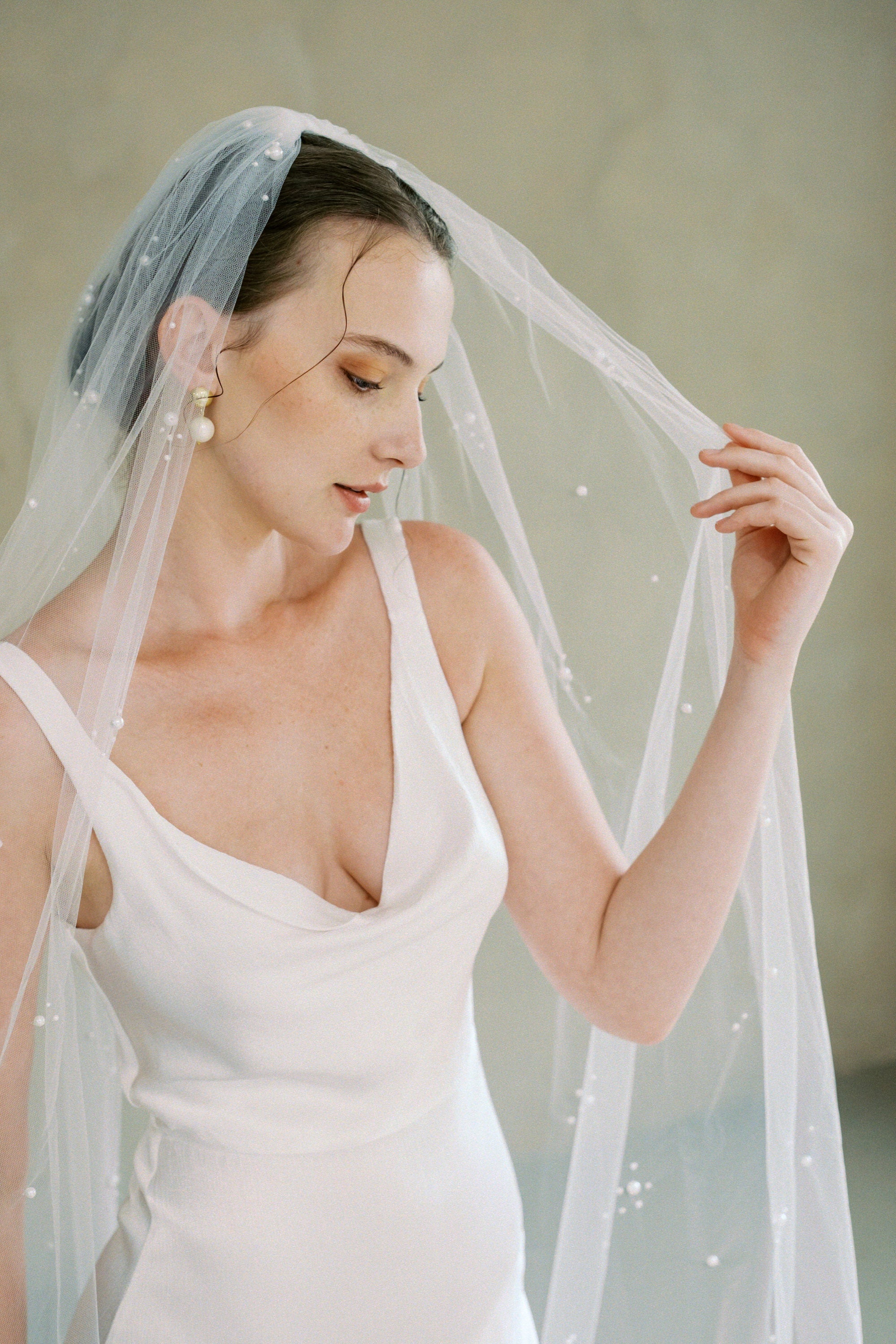 Model wears a one tier pearl wedding veil made by Madame Tulle bridal