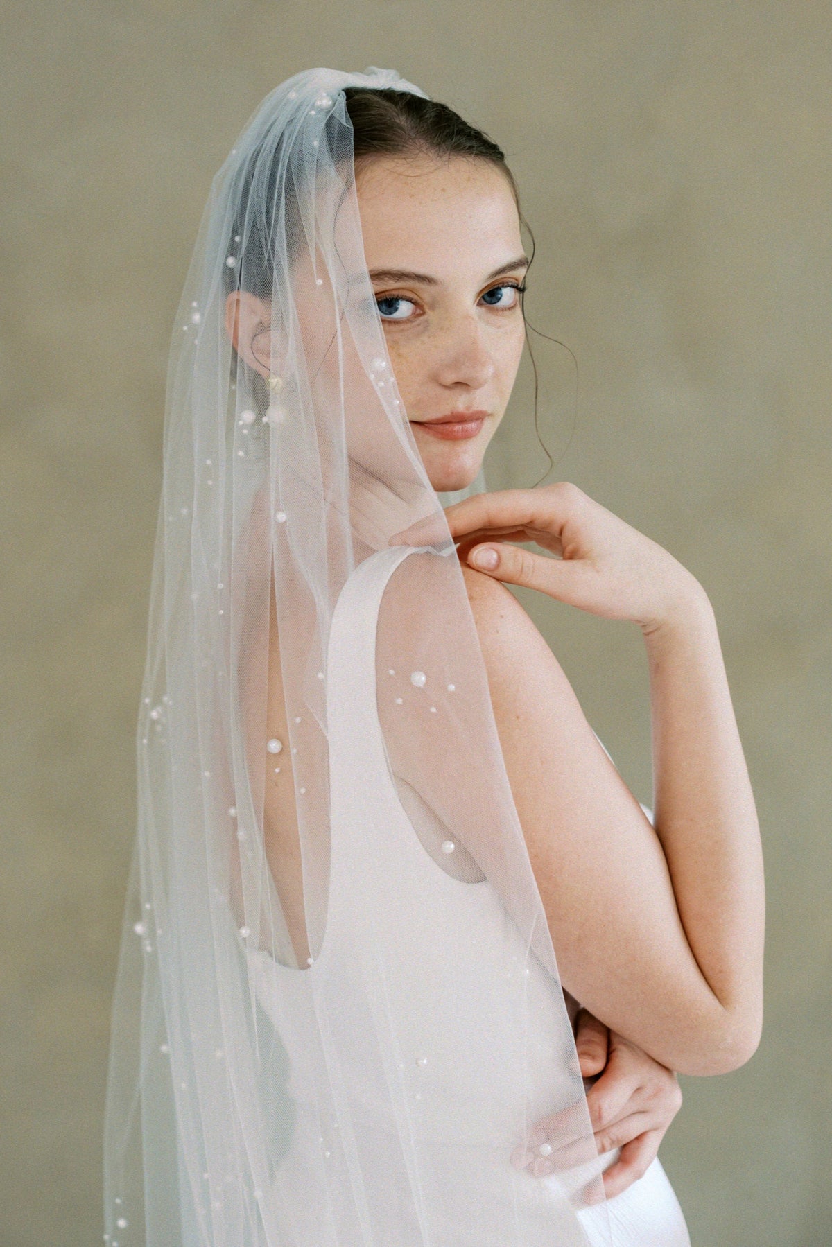 Model wears a one tier pearl wedding veil made by Madame Tulle bridal