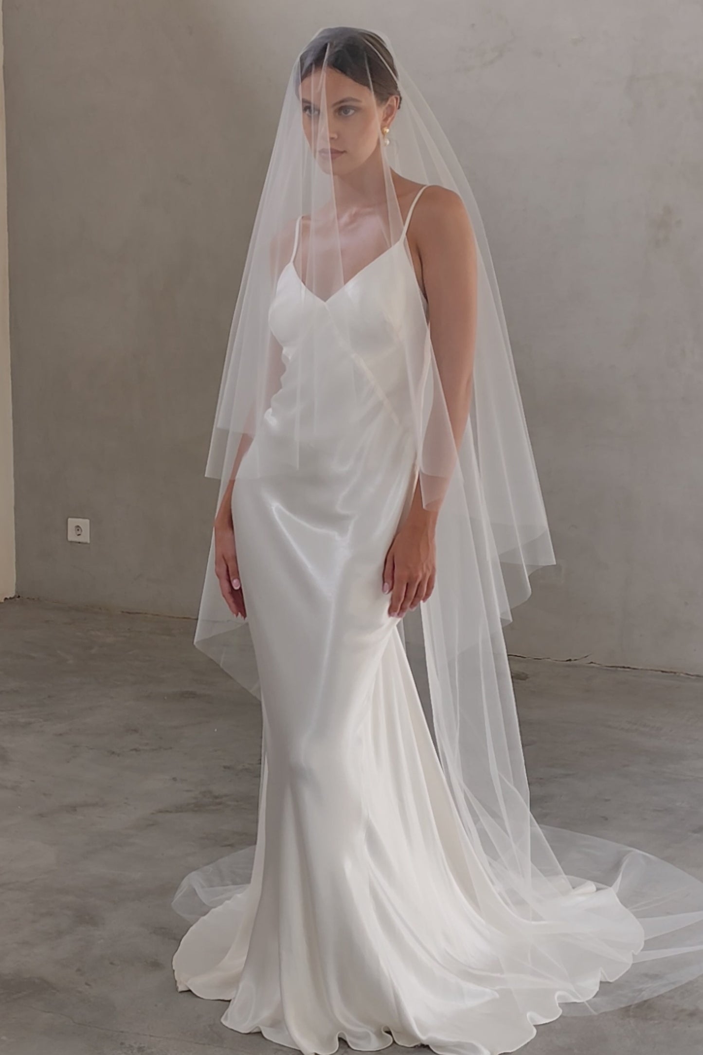 Full length shot of bride wearing long minimalist veil with blusher