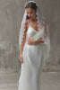 Full lace mantilla wedding veil drapes over the hair and shoulders of front facing bride