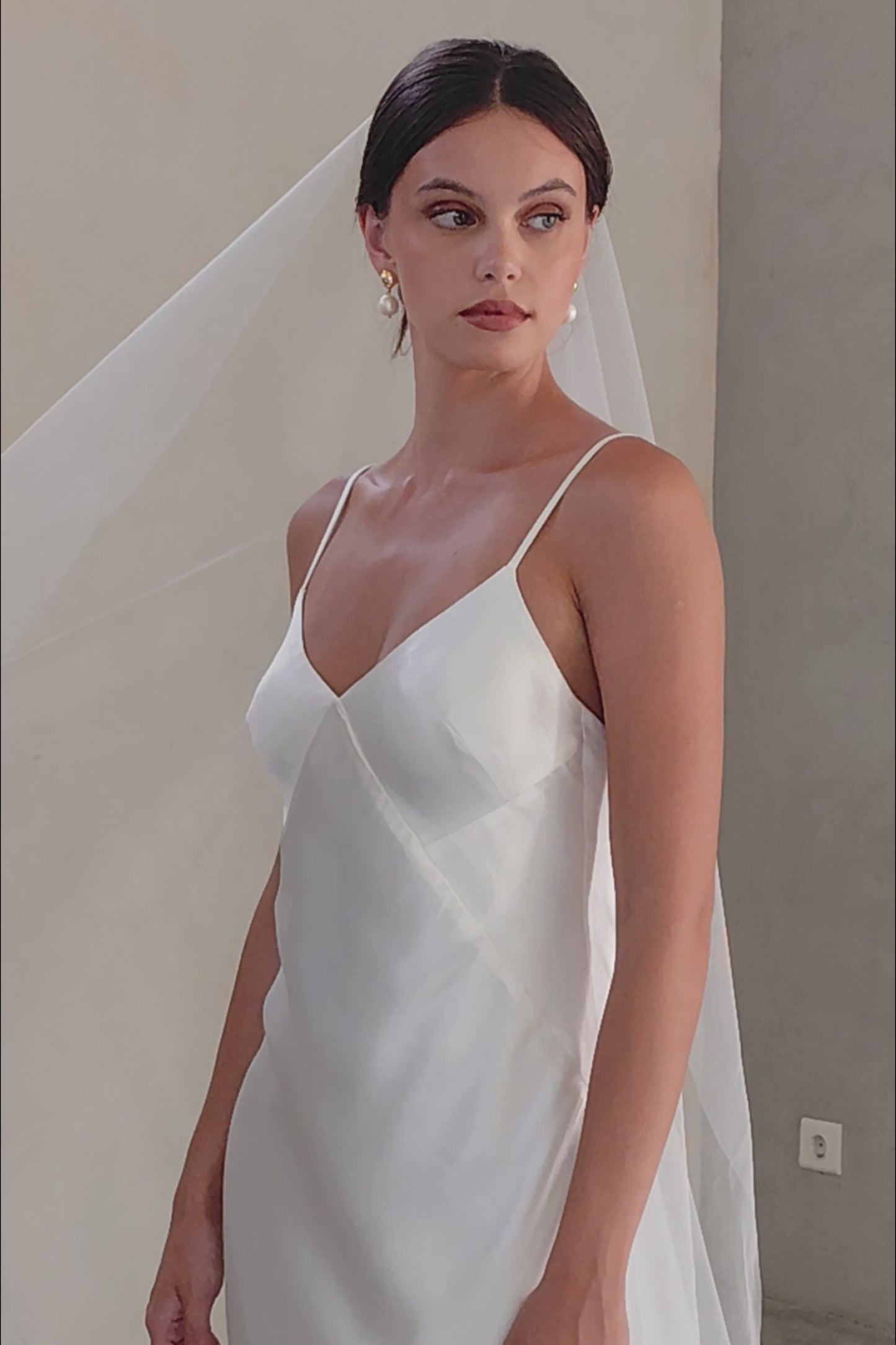 Half-length, front-facing view of bride wearing simple mantilla-style bridal veil - shimmer tulle