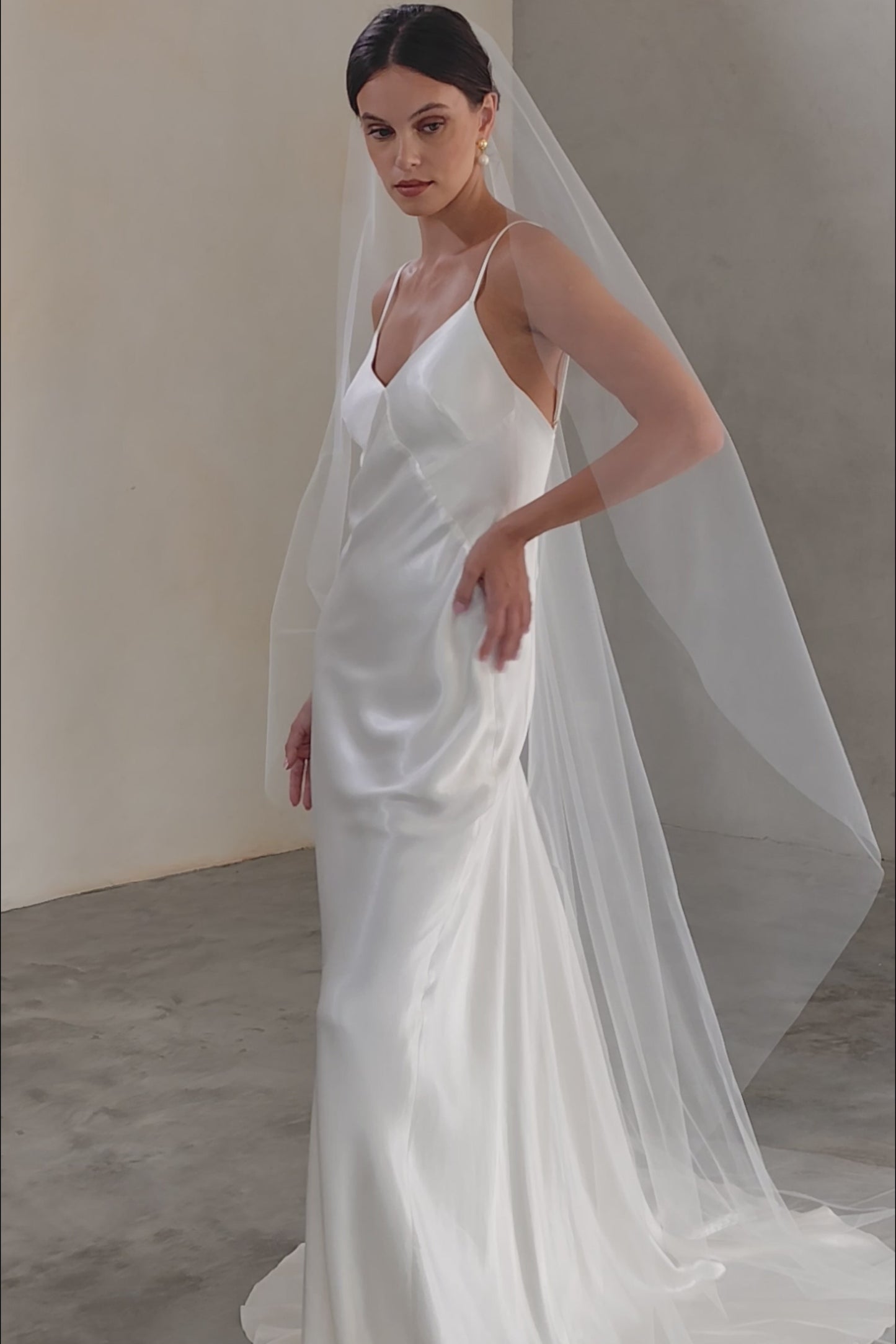 Full length front facing bride wearing long minimalist veil gathered at the comb