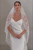Front facing bride wears angelic soft, sheer lace mantilla veil edged with delicate lace scallops