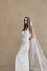 Model wears a pearl wedding veil, one tier veil with pearls.