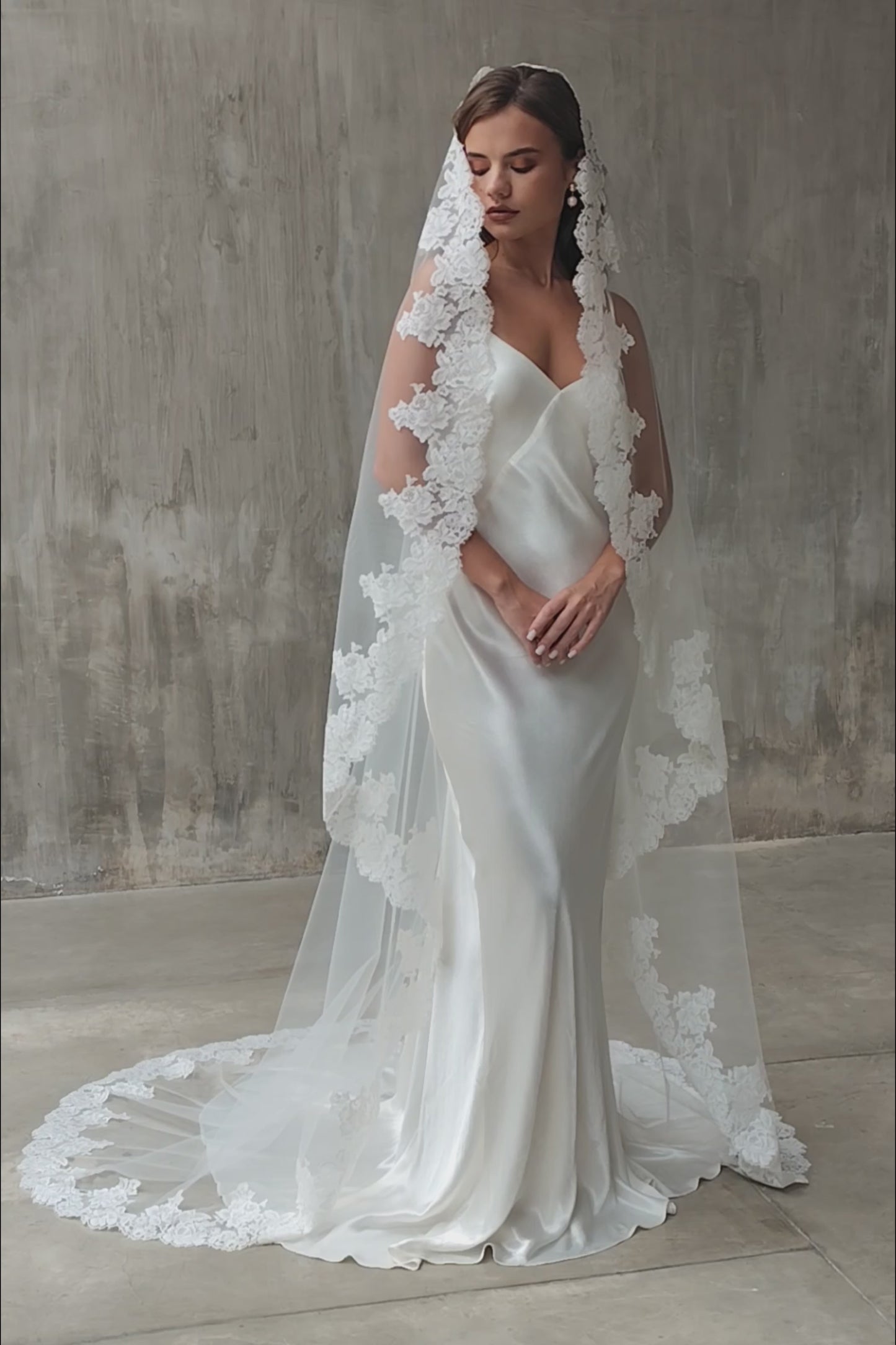 Full length shot of model wearing one-tier, laced edged wedding veil