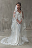 Full length shot of model wearing one-tier, laced edged wedding veil
