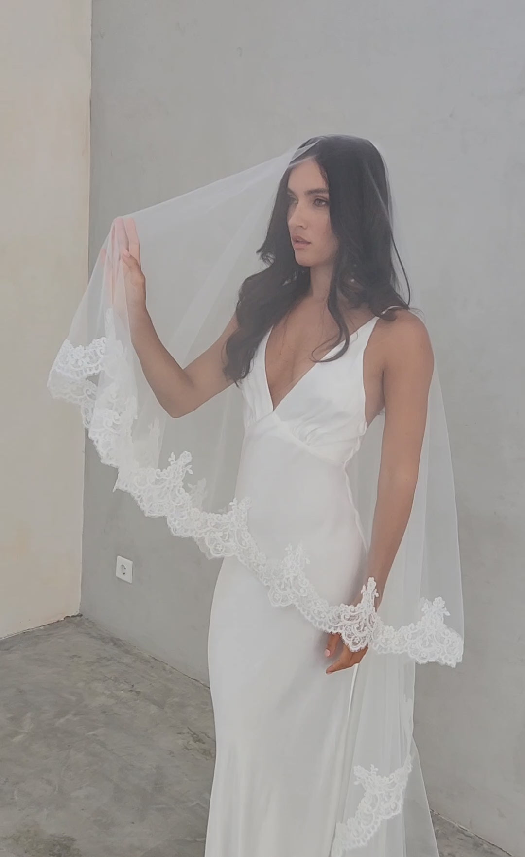 model wears a mantilla lace trim veil, drop lace edged wedding veil