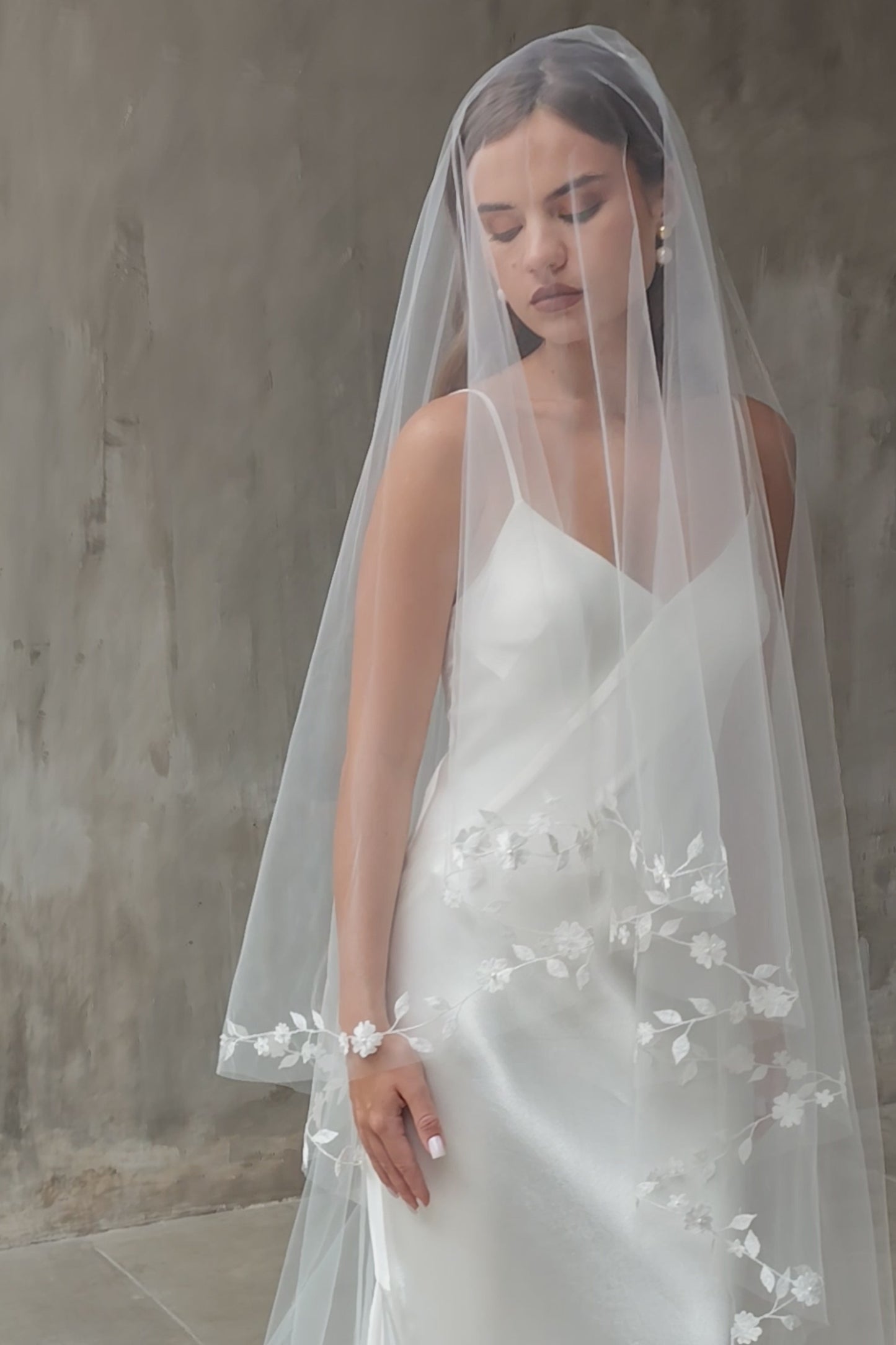 Blusher of wedding veil drapes to feature floral vine-style embroidery along the dges