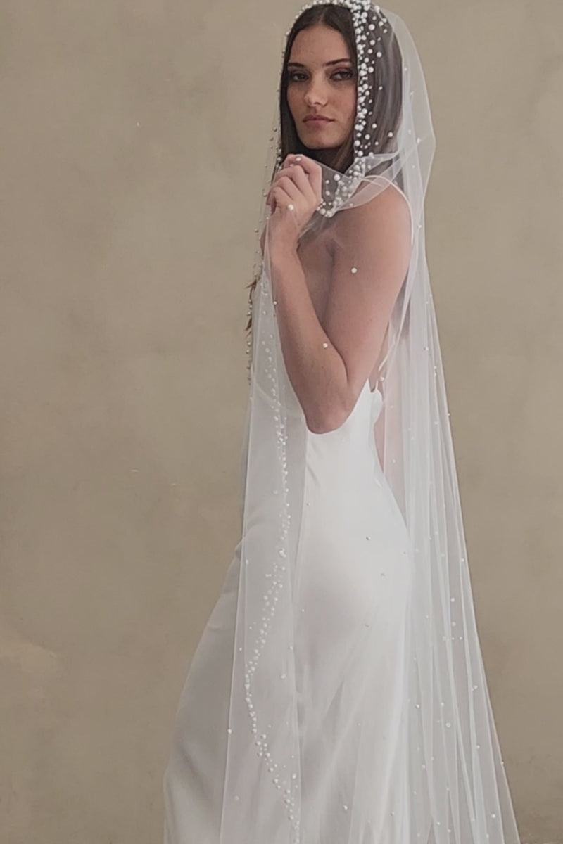 Model wears a pearls and sequins wedding veil, one tier veil