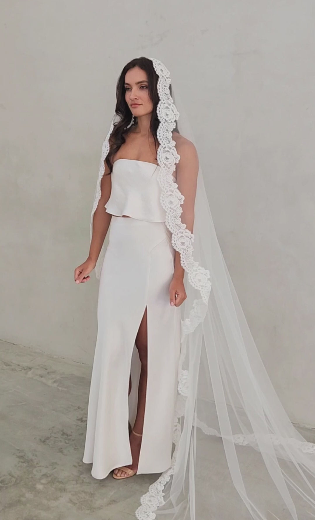 model wears mantilla veil, one-tier lace trim wedding veil