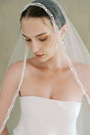 model wears a mantilla pearl edge veil
