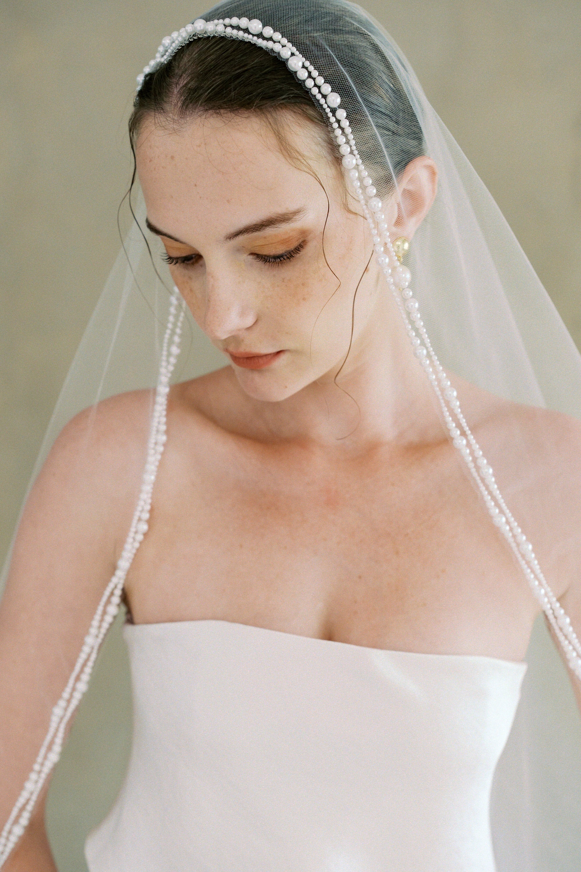 model wears a one-tier mantilla pearl edge veil