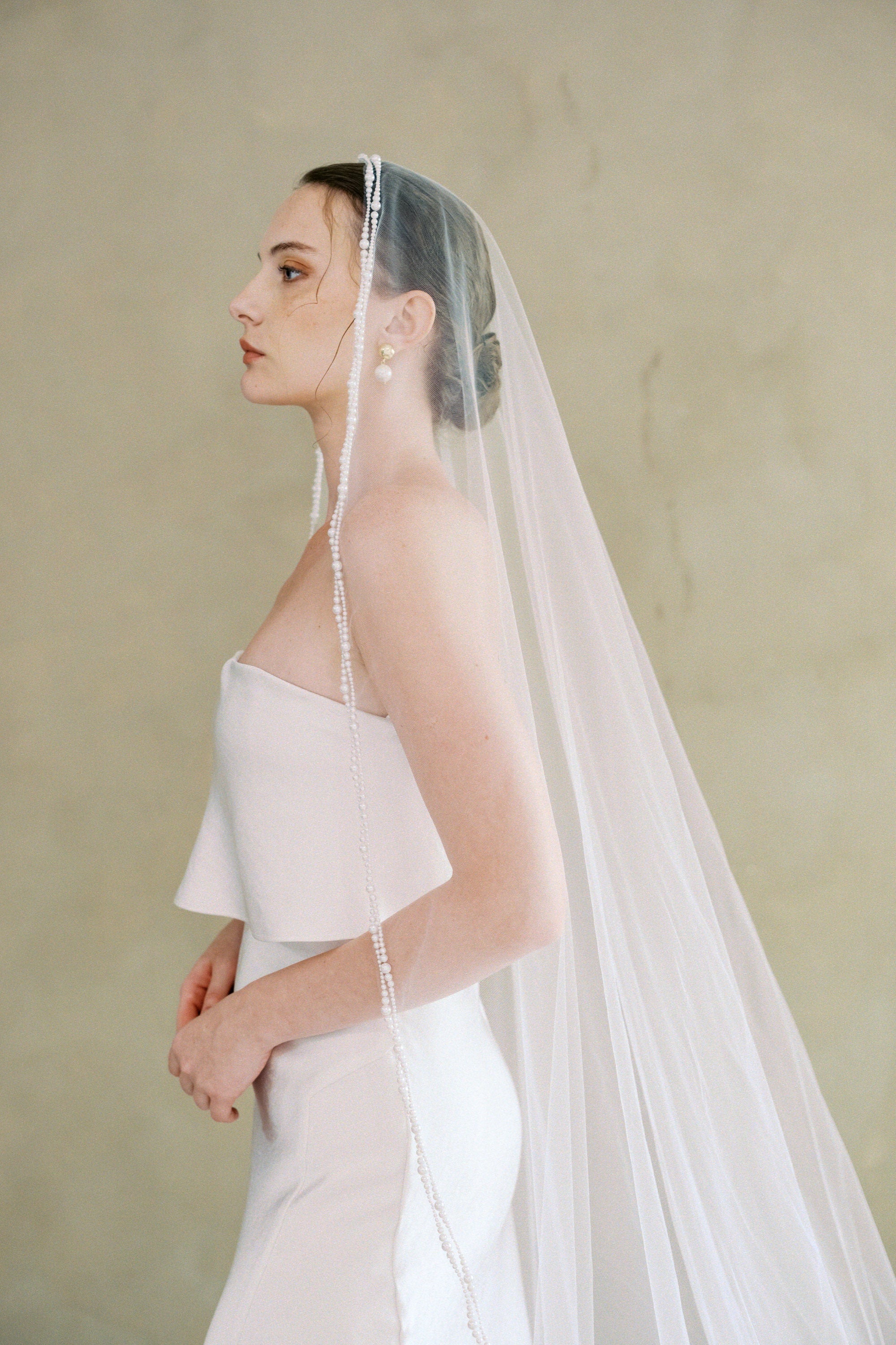 model wears a one-tier mantilla pearl edge veil
