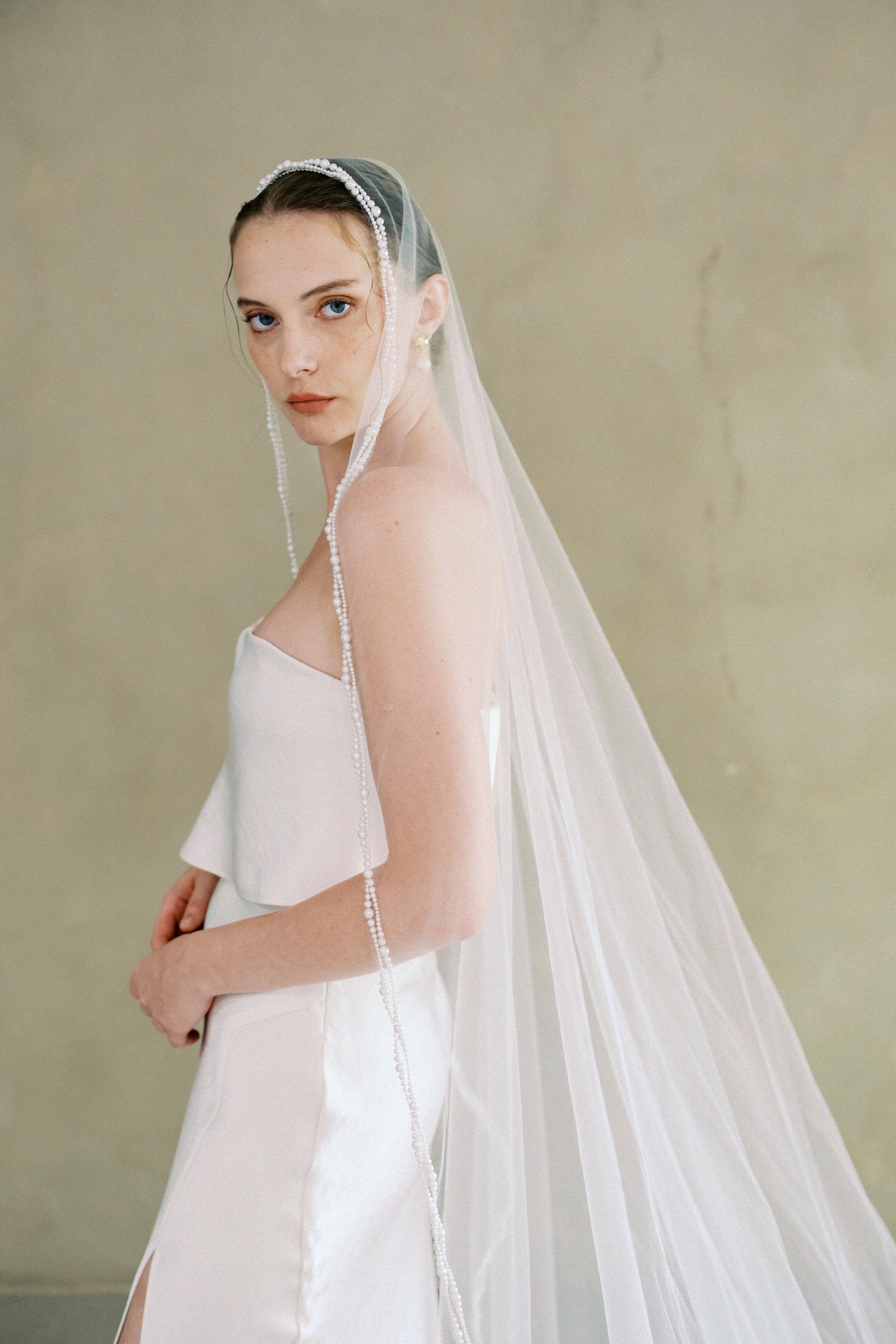 model wears a one-tier mantilla pearl edge veil