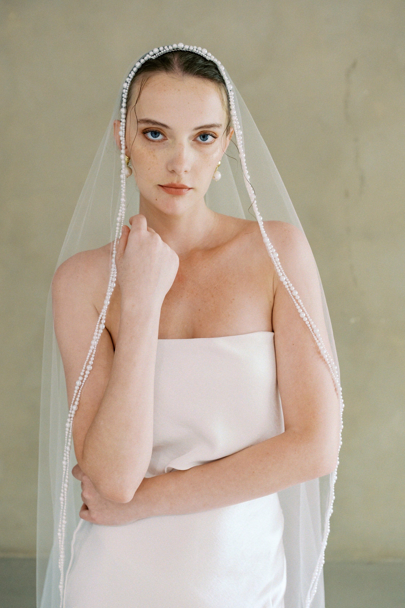model wears a one-tier mantilla pearl edge veil