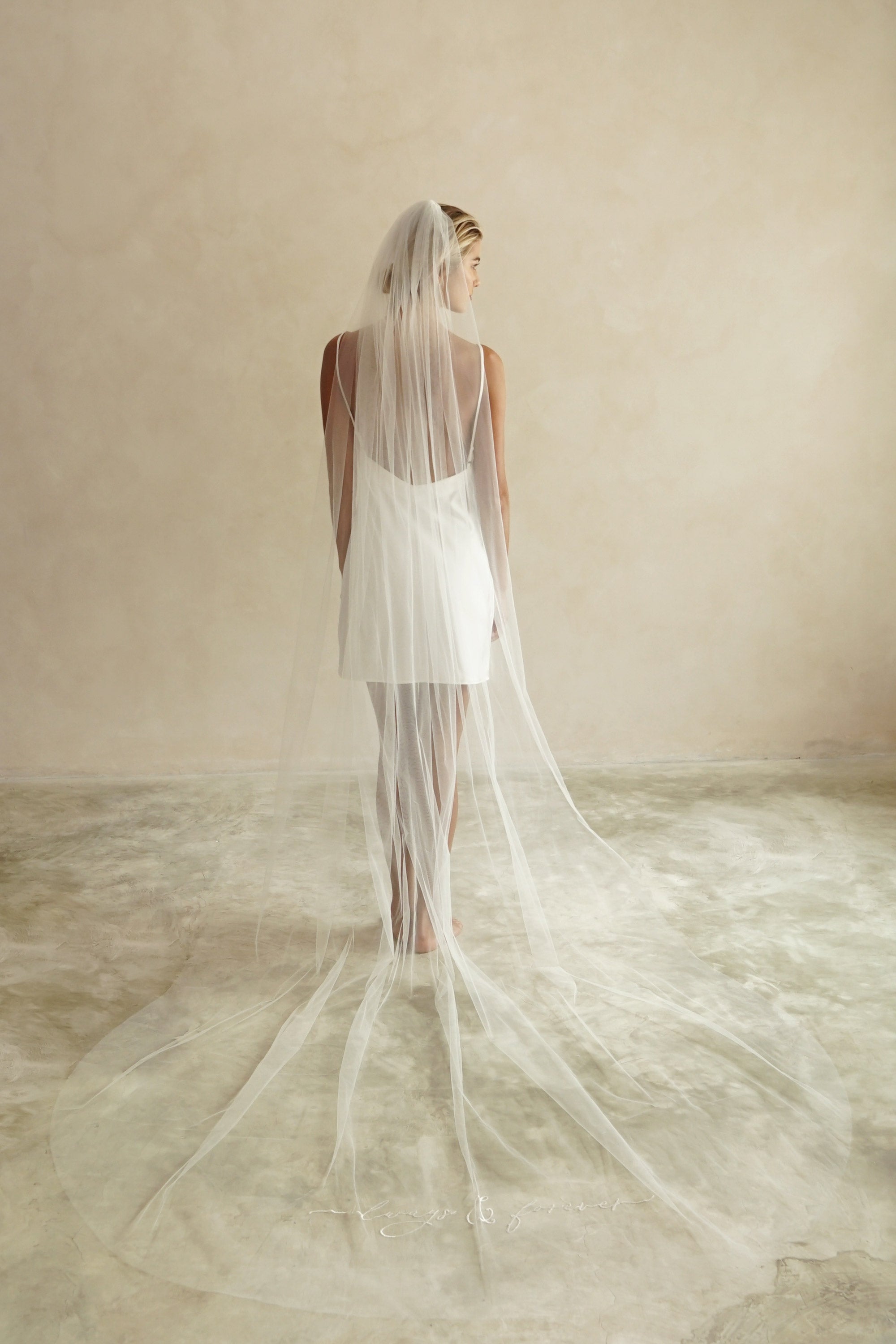 A model wearing always and forever embroidered veil by Madame Tulle bridal