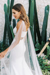 Model wears a detachable tulle wings with pearls