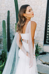 Model wears a detachable tulle wings with pearls