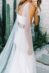 Model wears a detachable tulle wings with pearls