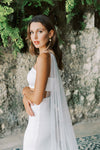 Model wears a detachable tulle wings with pearls