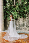 Model wears a detachable tulle wings with pearls