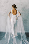 Model wears a detachable tulle wings with pearls