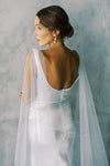 Model wears a detachable tulle wings with pearls