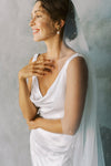 A model wearing a one tier wedding veil with pearls