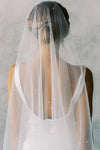 A model wearing a one tier wedding veil with pearls