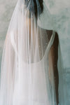 A model wearing a two tier wedding veil with pearls