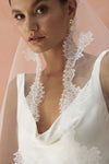 A model wearing CELINE I, a lace Mantilla wedding veil by Madame Tulle