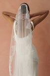 A model wearing CELINE I, a lace Mantilla wedding veil by Madame Tulle