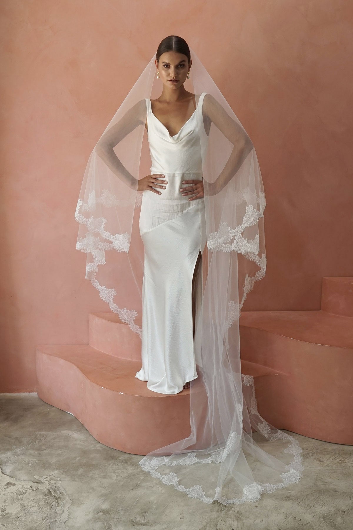 A model wearing CELINE II, a two tier lace wedding veil by Madame Tulle