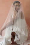 A model wearing CELINE II, a two tier lace wedding veil in cathedral length by Madame Tulle