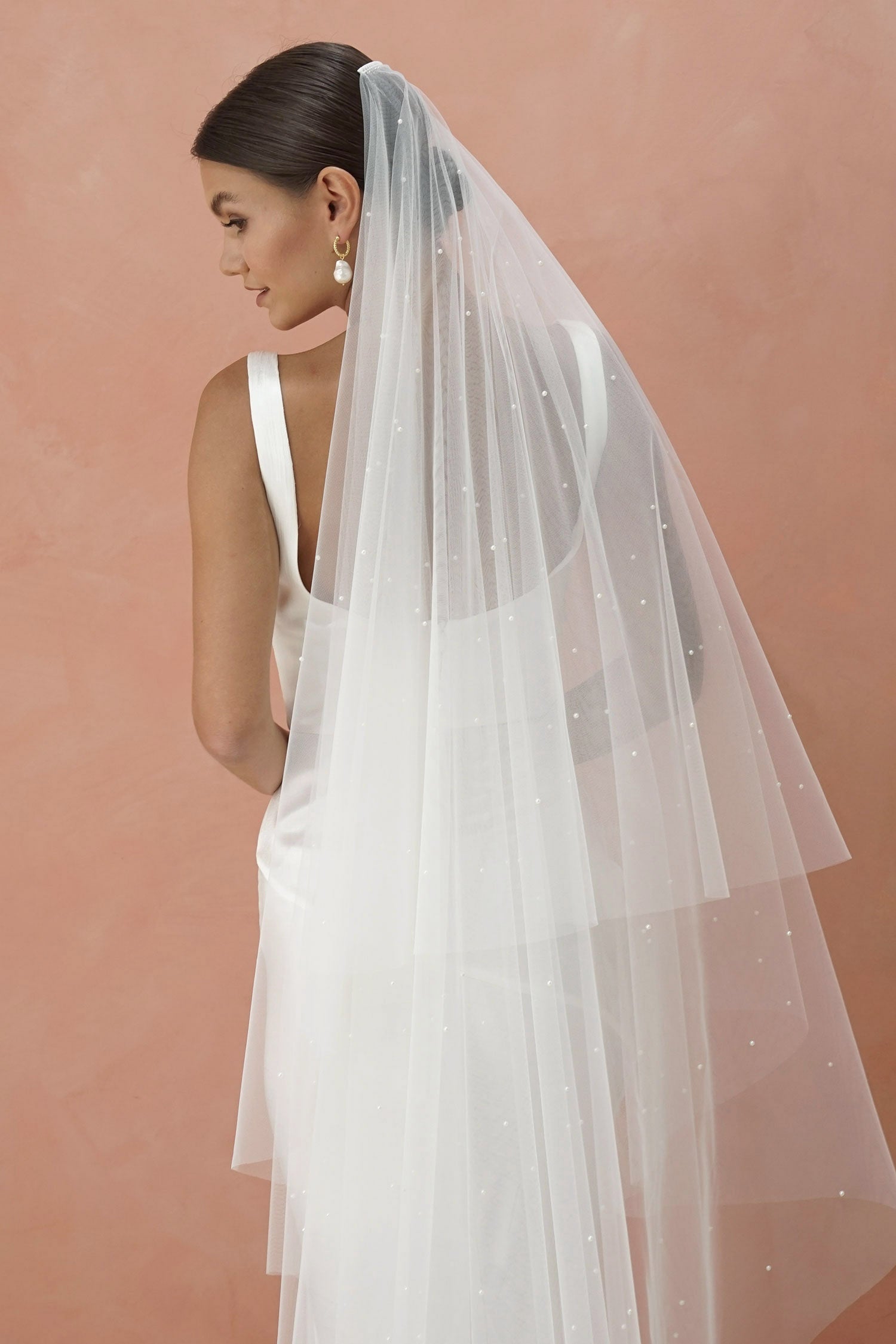 A model wearing two tier wedding veil with small pearls, drop veil
