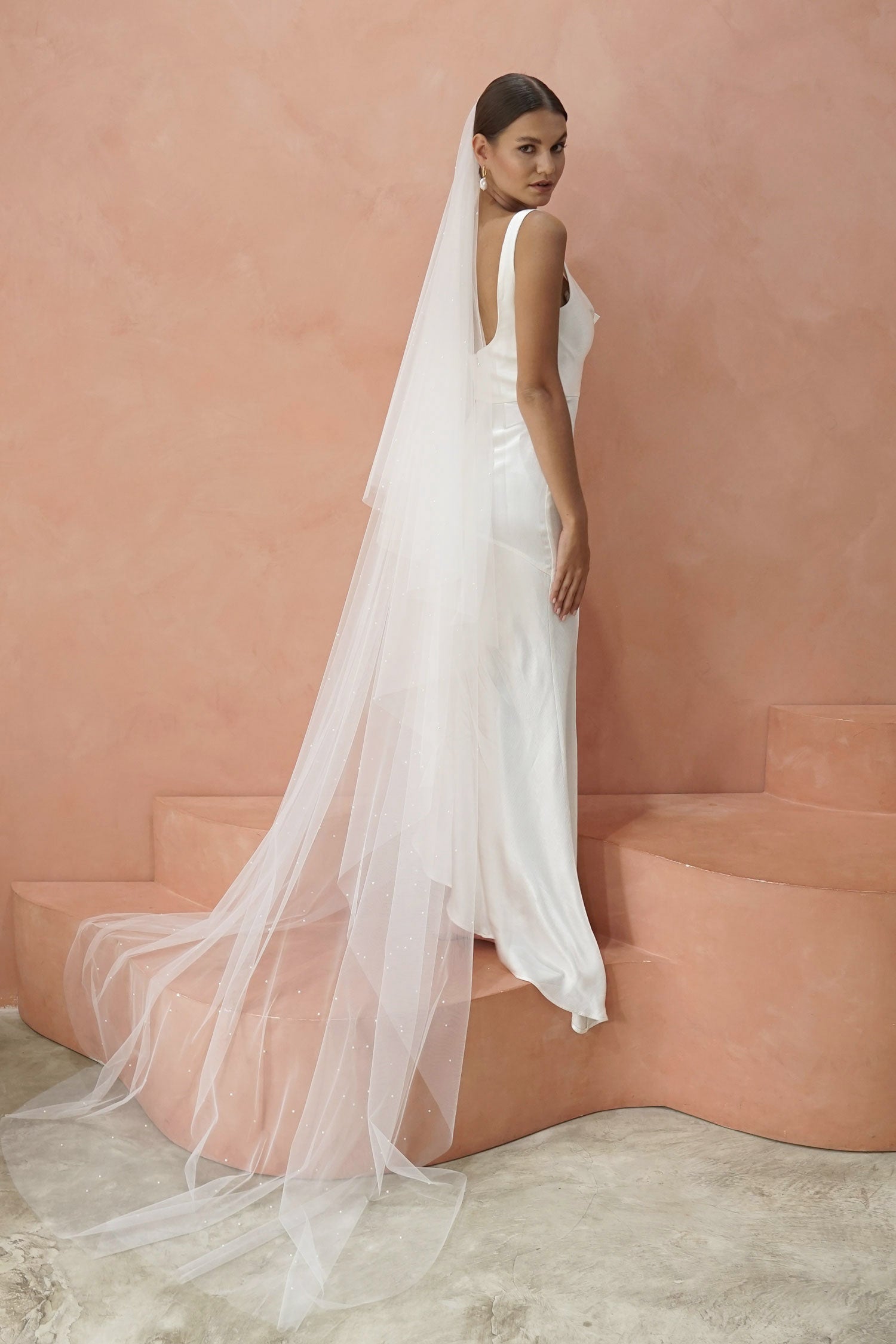 A model wearing two tier wedding veil with small pearls, drop veil