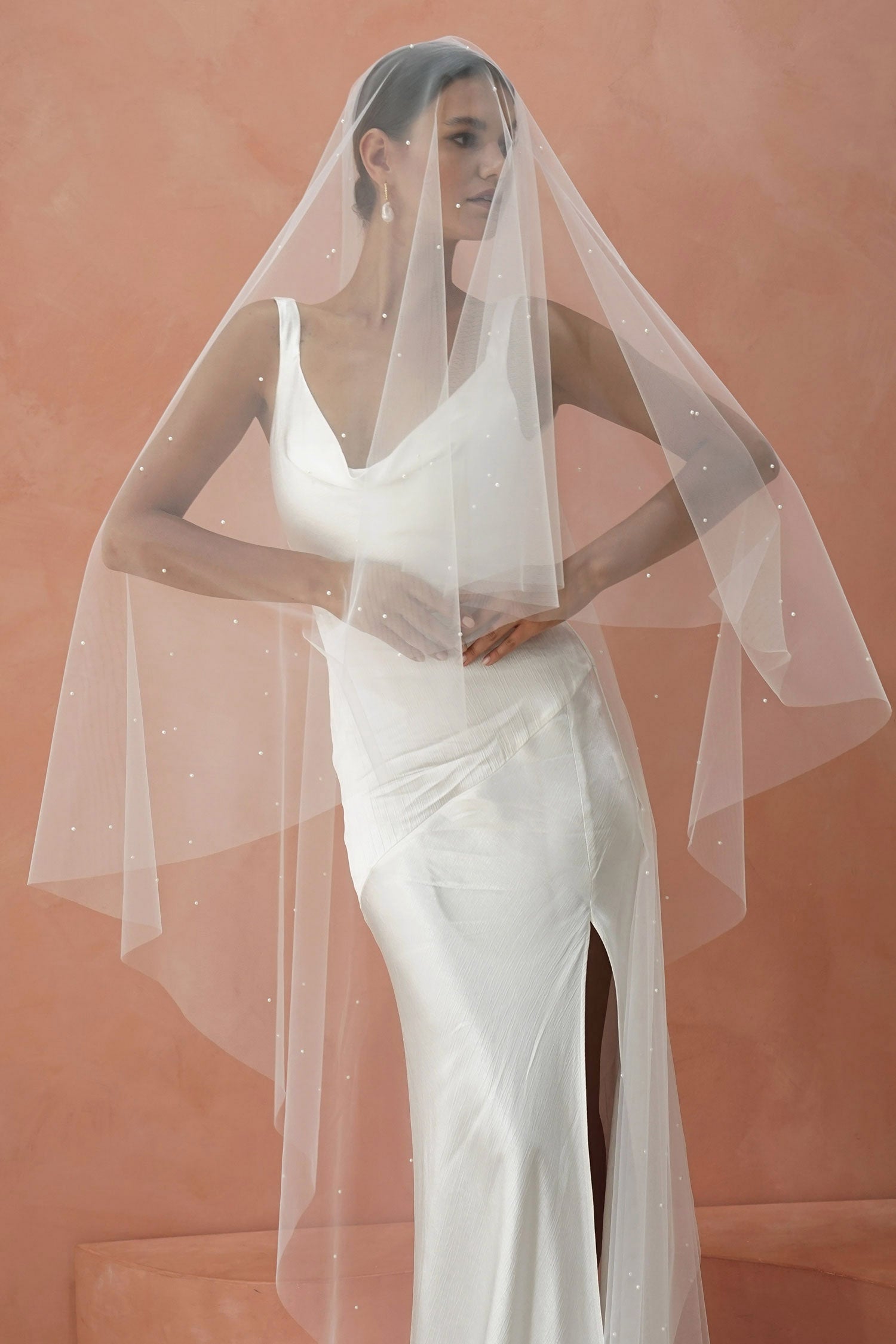 A model wearing two tier wedding veil with small pearls, drop veil