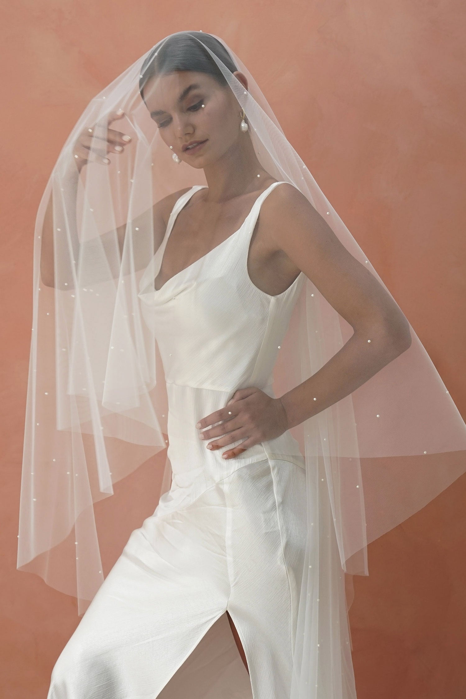 A model wearing two tier wedding veil with small pearls, drop veil