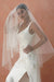 A model wearing the CHLOE two tier wedding veil with small pearls