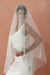 A model wearing the CHLOE two tier wedding veil with small pearls