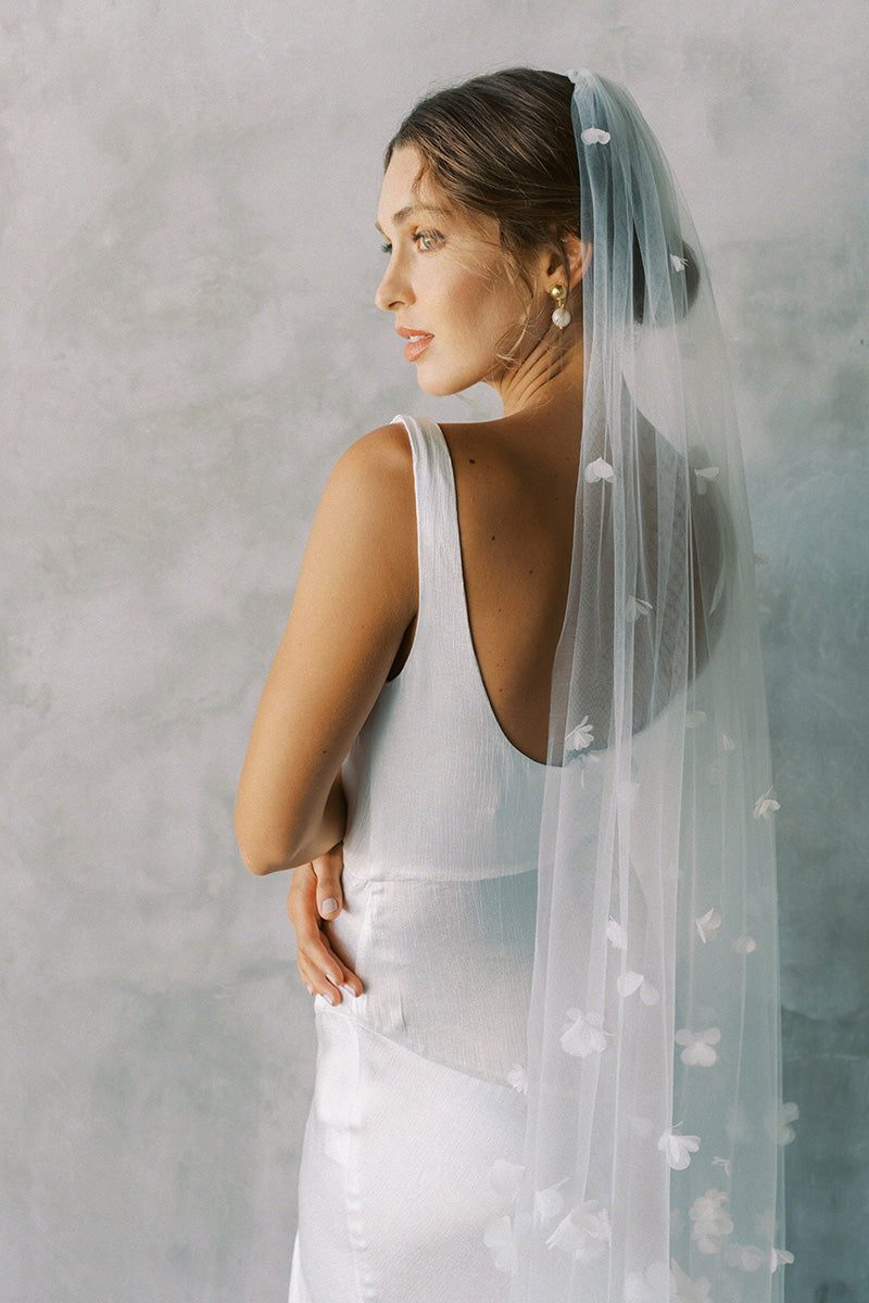 model wears one tier three dimensional organza flowers, wedding veil with flowers