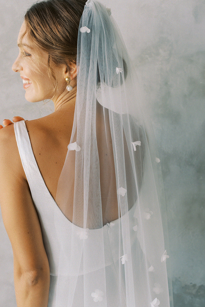 model wears one tier three dimensional organza flowers, wedding veil with flowers