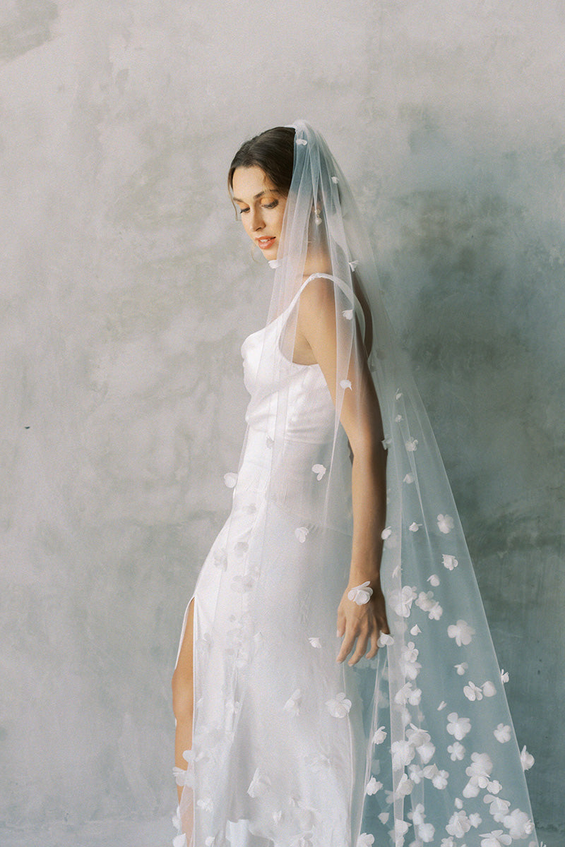 model wears one tier three dimensional organza flowers, wedding veil with flowers