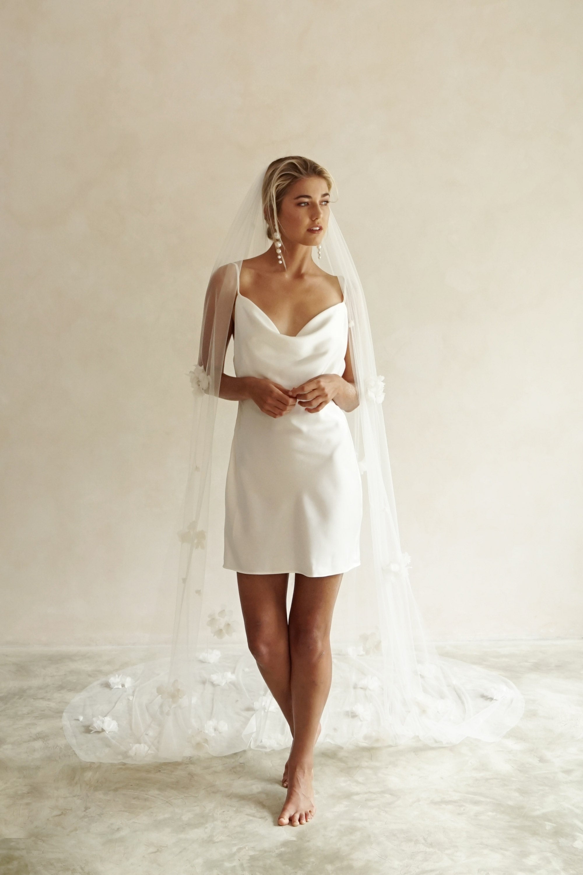 model wears wedding veil with fabric flowers, floral veil