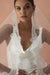 A model wearing COLETTE I, a lace Mantilla veil