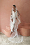 A model wearing COLETTE I, a lace Mantilla one tier veil