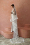 A model wearing COLETTE II, a two tier lace wedding veil by Madame Tulle