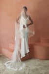 A model wearing COLETTE II, a two tier lace wedding veil