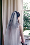 A model wearing MARIBEL II two tier pearl wedding veil by Madame Tulle