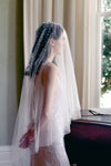 A model wearing MARIBEL II two tier pearl wedding veil by Madame Tulle